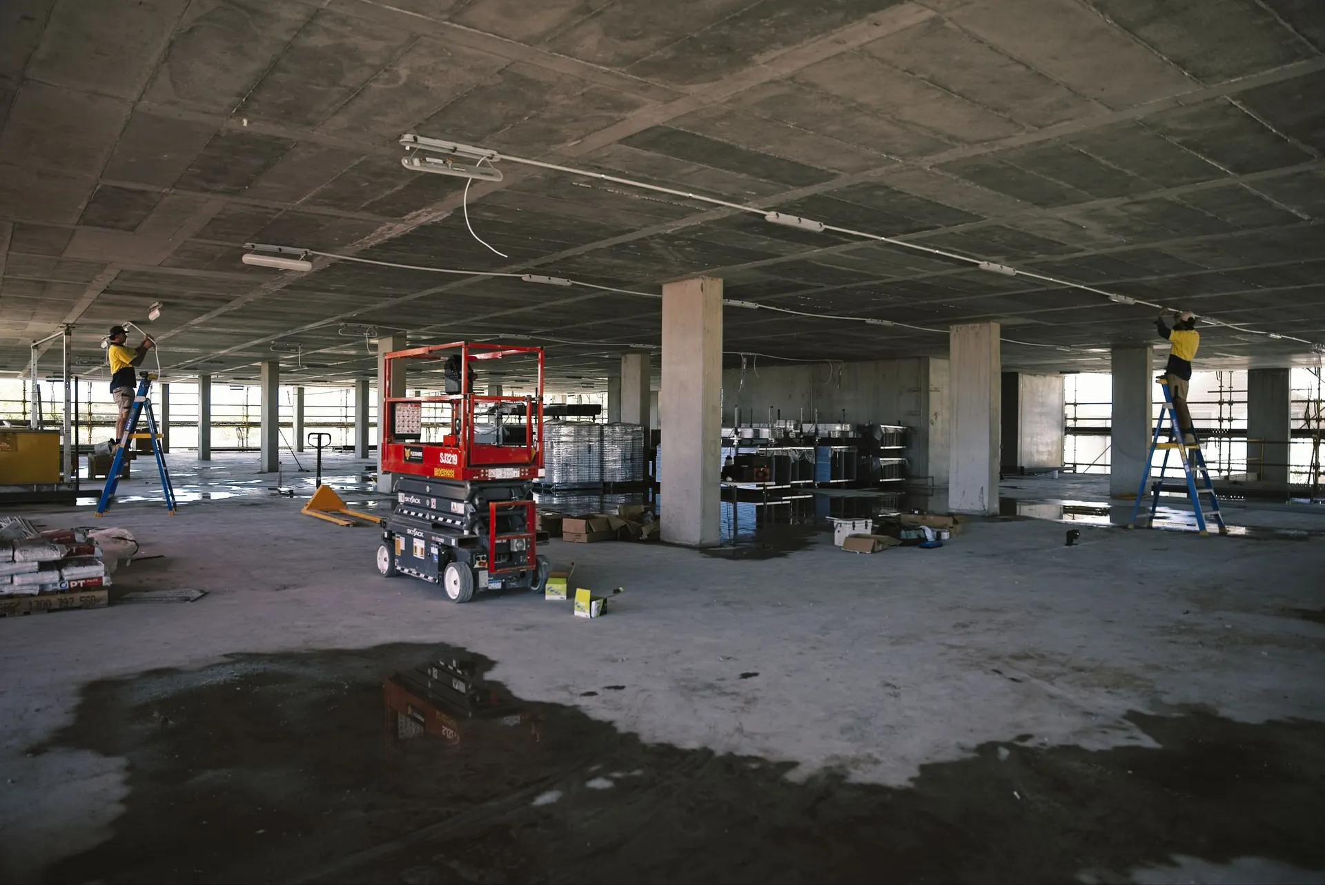 Electrician working from an EWP in a commercial building